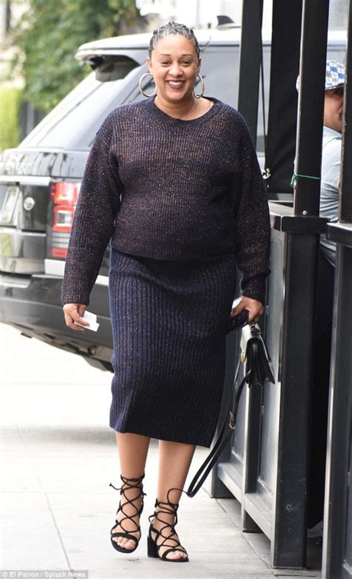 Pregnant Tia Mowry covers her growing baby bump in chic wardrobe